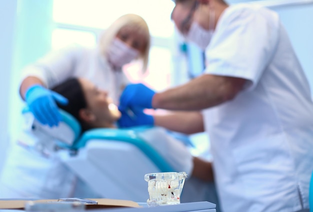 Dentist man with patient woman in clinic