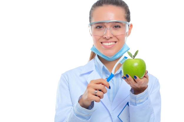 Dentist medical doctor woman hold green fresh apple in hand and tooth brush Dentist doctors Woman doctors