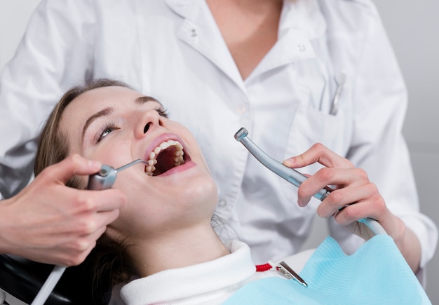 Dentist performing teeth treatment