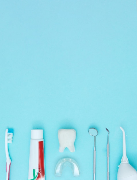 Dentist Professional tools medical equipment toothbrush toothpaste and Tooth model on Blue background Dental Hygiene and Health conceptual image