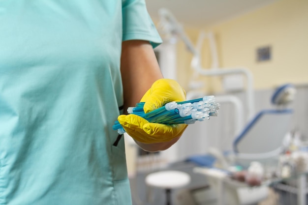 Dentist's hand in glove with saliva ejectors