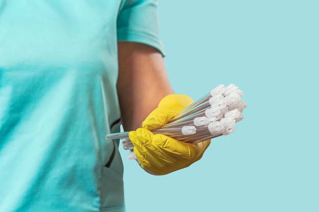 Dentist's hand in glove with saliva ejectors