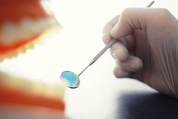 Dentist's office. dentist examines the oral cavity before treatment. the doctor shows a course of treatment. caries jaw treatment. implantation and installation of veneers.