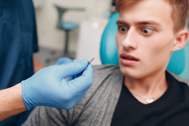 Dentist showing implant to patient in a dental clinic