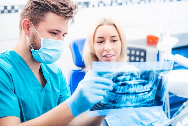 Dentist showing patient dental xray