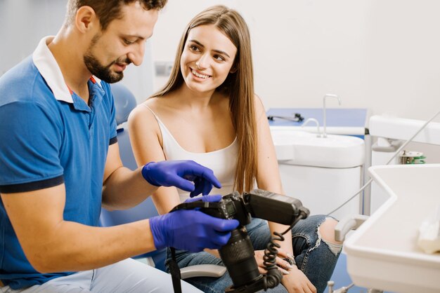 Dentist showing photos of teeth on camera to the patient