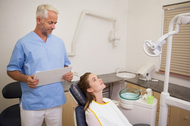 Dentist standing over patient in the chair