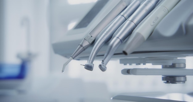 Dentist takes a dentistry drill tools and starts working dental instruments