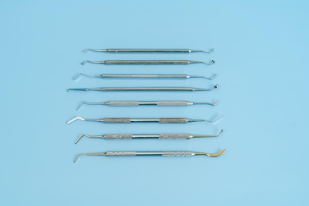 Dentist tool set Teethcare dental health concept Blue background top view copy space