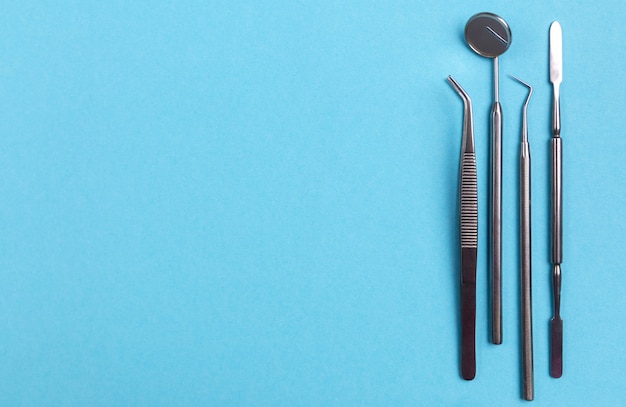 Dentist tools and artificial jaw on bright yellow and violet background. The concept of dental care and going to dentistry