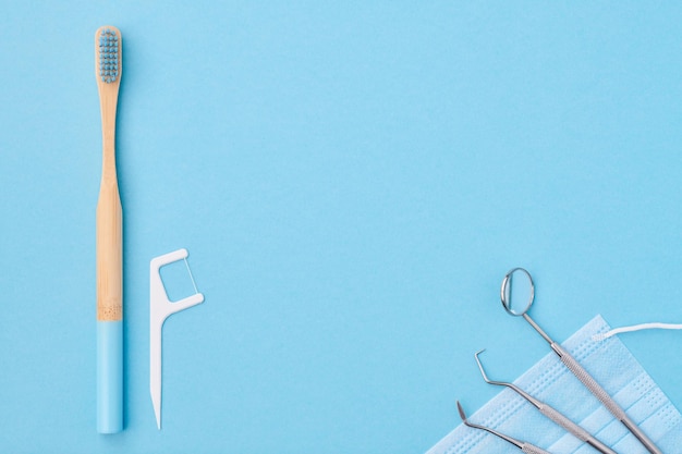 Photo dentist tools over blue background top view