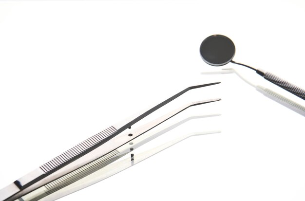 Dentist tools on white background with copy space closeup