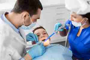 Photo dentist treating kid teeth at dental clinic