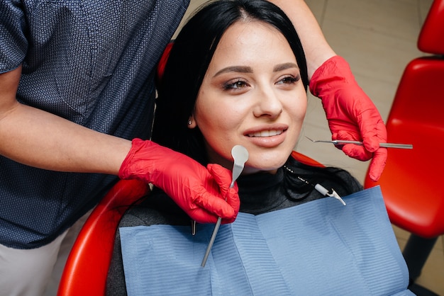 The dentist treats the girl's teeth to the patient. Dentistry. Close up.