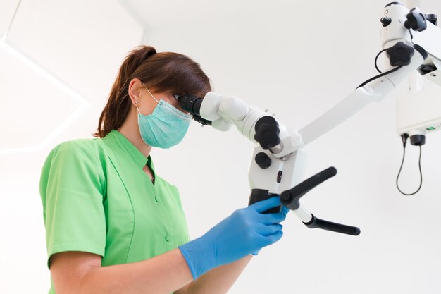 Dentist using microscope