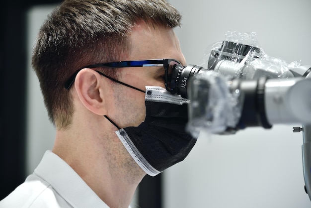 Dentist using microscope