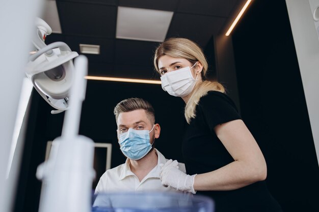 A dentist with dental assistant in modern dental surgery