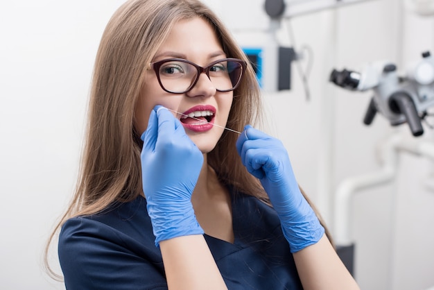 Dentist with dental floss