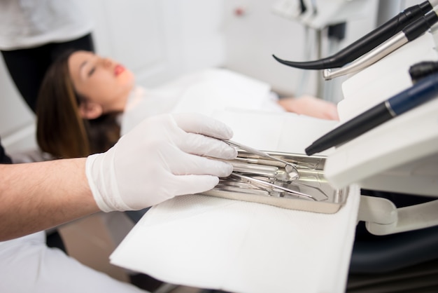 Dentist with gloved hands treating a patient