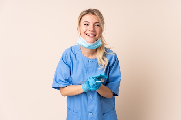 Dentist woman holding tools applauding