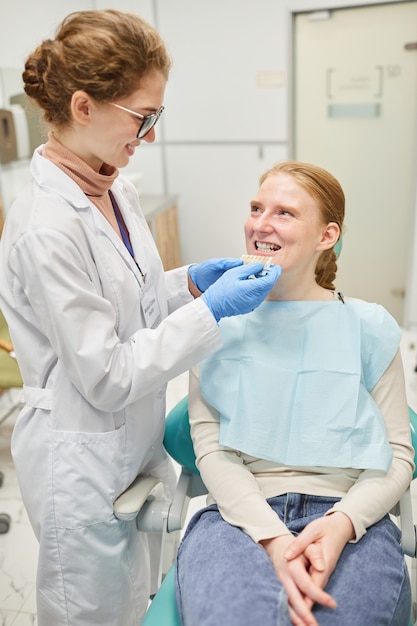 Dentist working with patient they choosing implants for new teeth