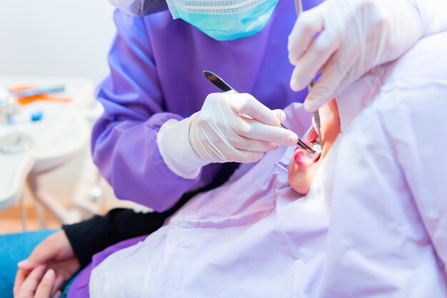 Dentistry and healthcare concept at dental clinic. Dentist check-up teeth for young asian patient.