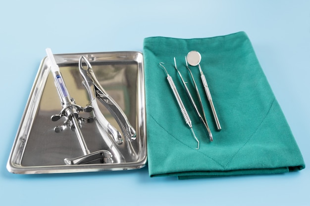 Dentistry medical tools forcept upper/ lower on blue background.