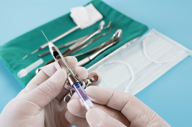 Dentistry medical tools syring on blue background.