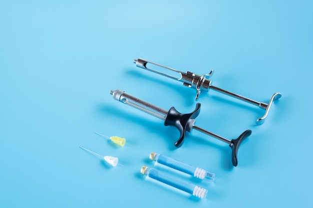 Photo dentistry medical tools syring on blue surface