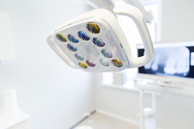 dentistry, medicine, medical equipment and stomatology concept - close up of lamp at dental clinic office