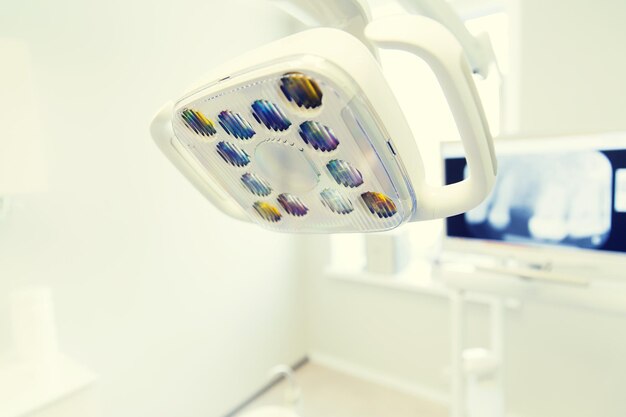 dentistry, medicine, medical equipment and stomatology concept - close up of lamp at dental clinic office