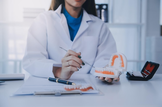 Dentists are discussing dental problems at report xray image on laptop screen to patients