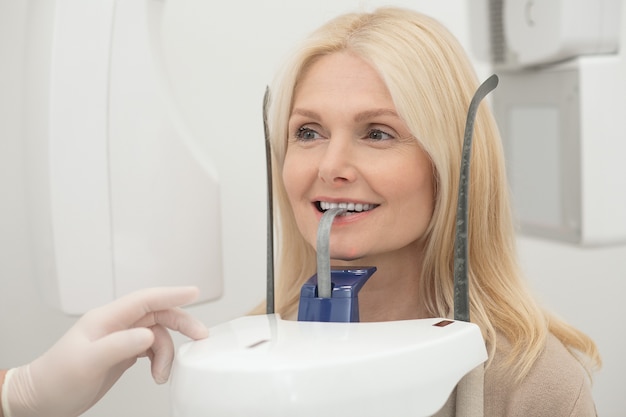 At the dentists. A blonde woman having procedures at the dentitst office