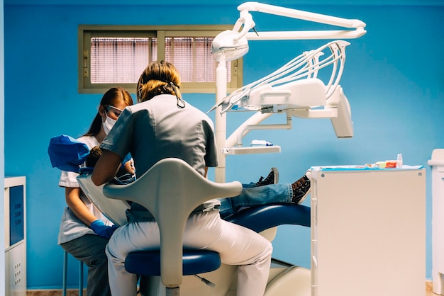 Dentists examining patient in clinic