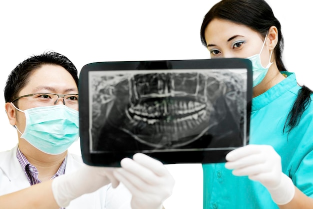 Photo dentists examining x ray on white background