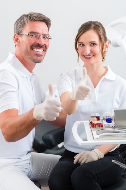 Dentists in their surgery or office with dental tools