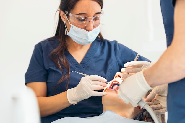 Dentists with a patient during a dental intervention. Medical Concept.