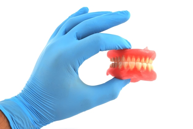 Dentures in hand