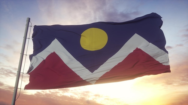 Denver city of Colorado flag waving in the wind, sky and sun background. 3d rendering