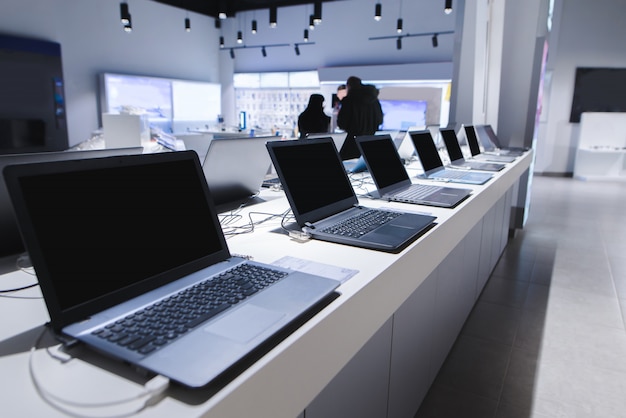 Department of computers in the electronics store. Choosing a laptop in the store