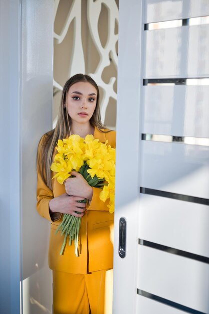 Depicts a person holding a bouquet of yellow flowers 4618