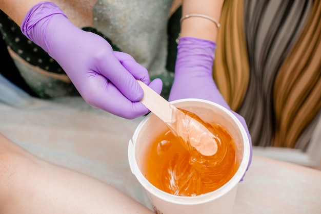 depilation and beauty concept sugar paste or wax honey for hair removing 