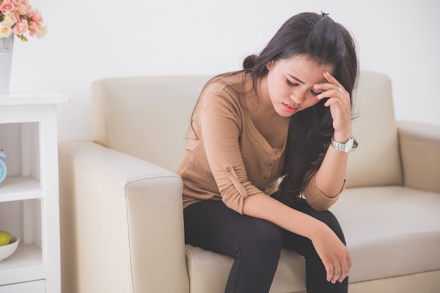 Depress woman touching her fore head