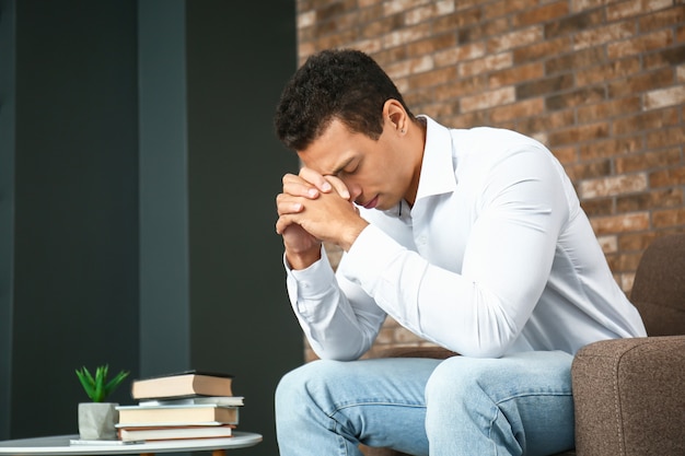 Depressed African-American man at home