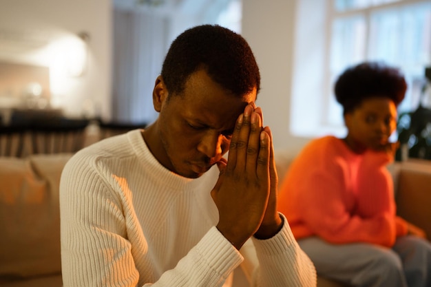 Depressed african american man think of divorce not looking at wife after betrayal or love affair