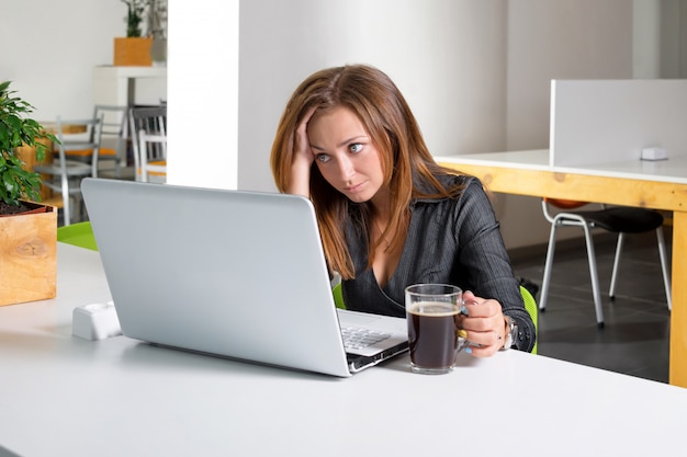 Depressed businesswoman sitting at computer