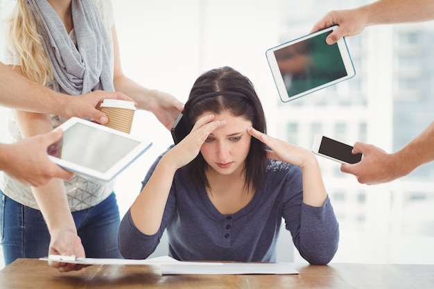 depressed businesswoman with head in hands