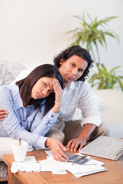 Depressed couple checking their bills