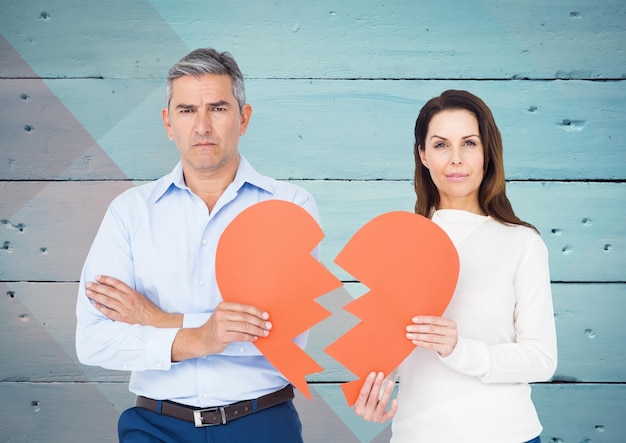 Depressed couple holding broken heart