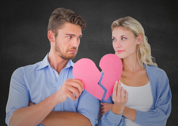 Depressed couple holding broken heart